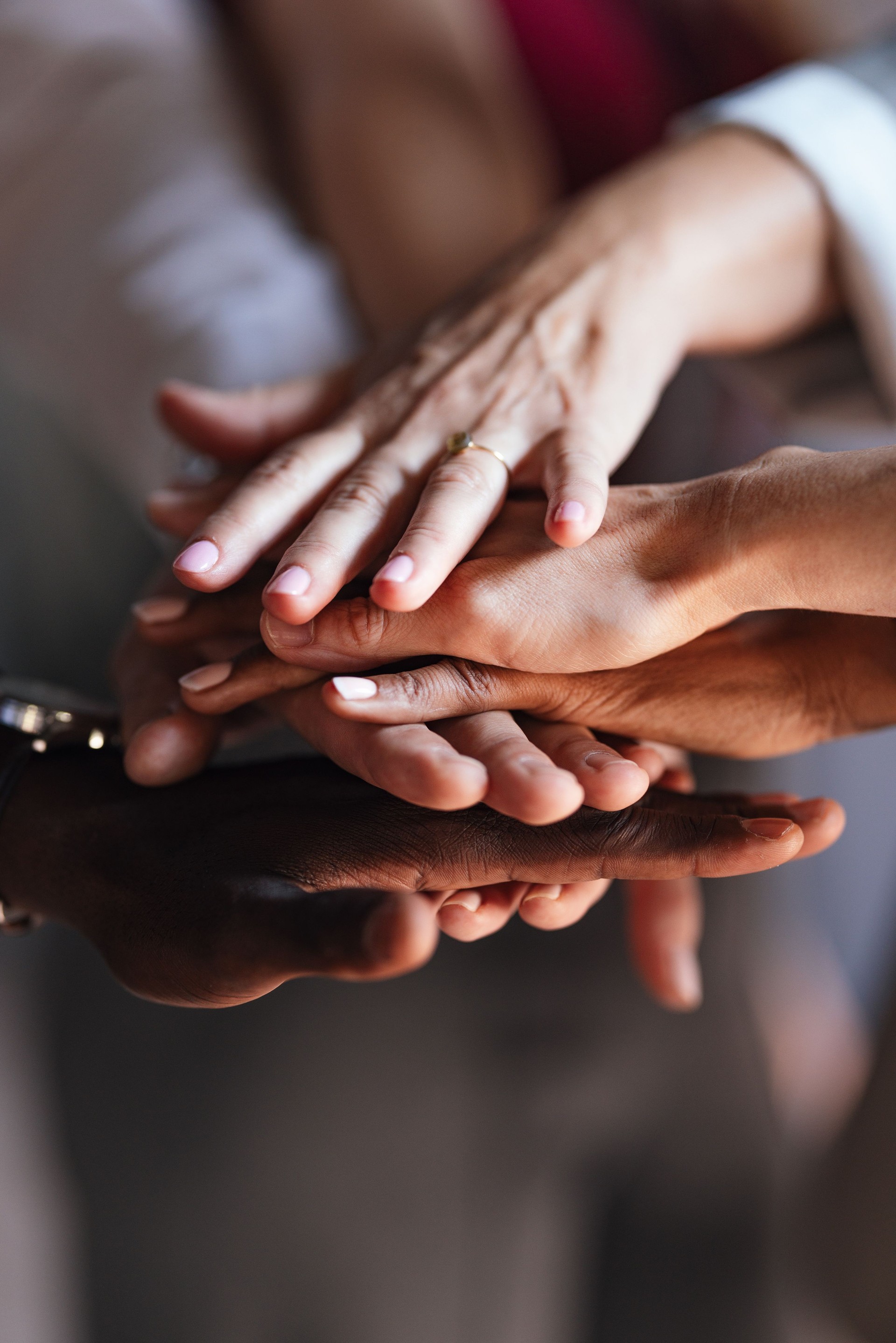 Diverse Team Uniting Hands in Symbol of Cooperation