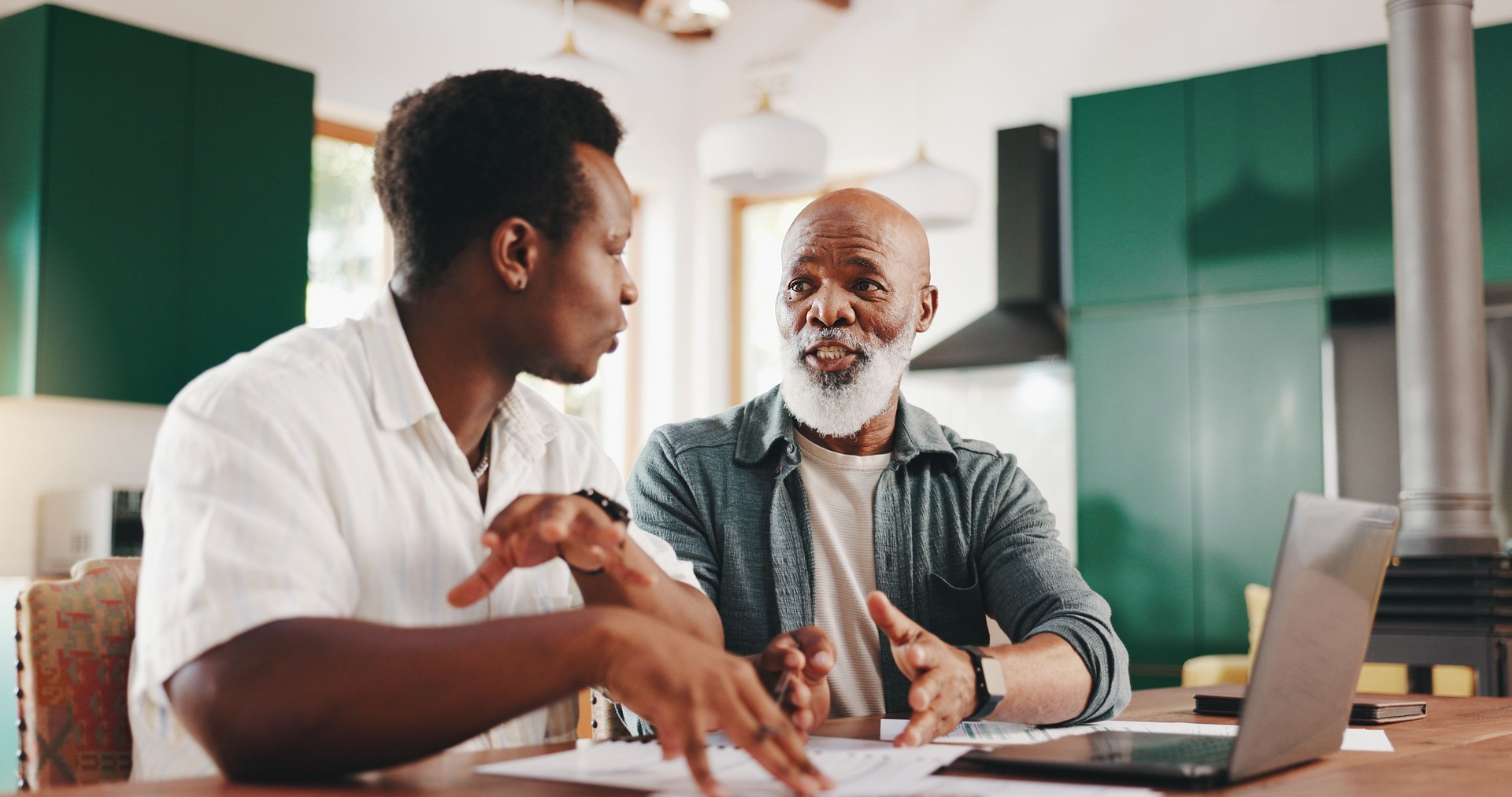 Father, son and help with bills in home for finance paperwork, advice or mortgage application with senior. Budget document, men or discussion for loan, debt or teaching investment with African family